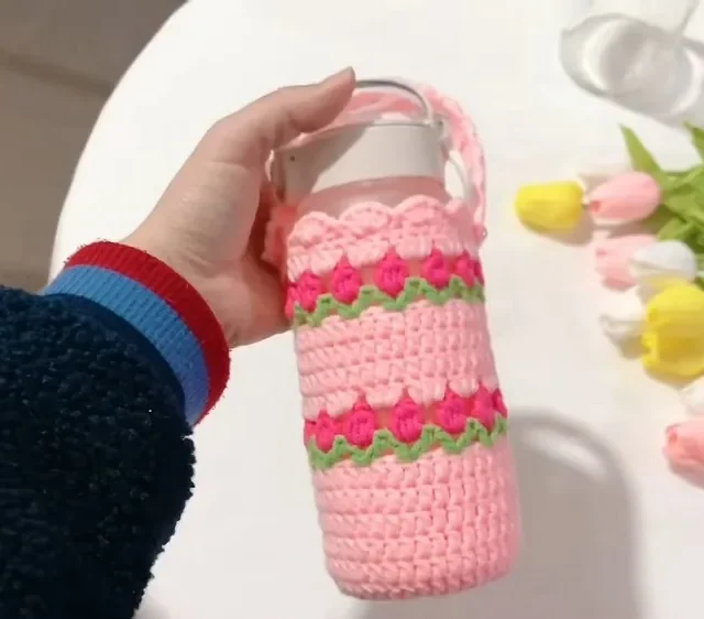 Double crochet water bottle holder with a pink flower trim